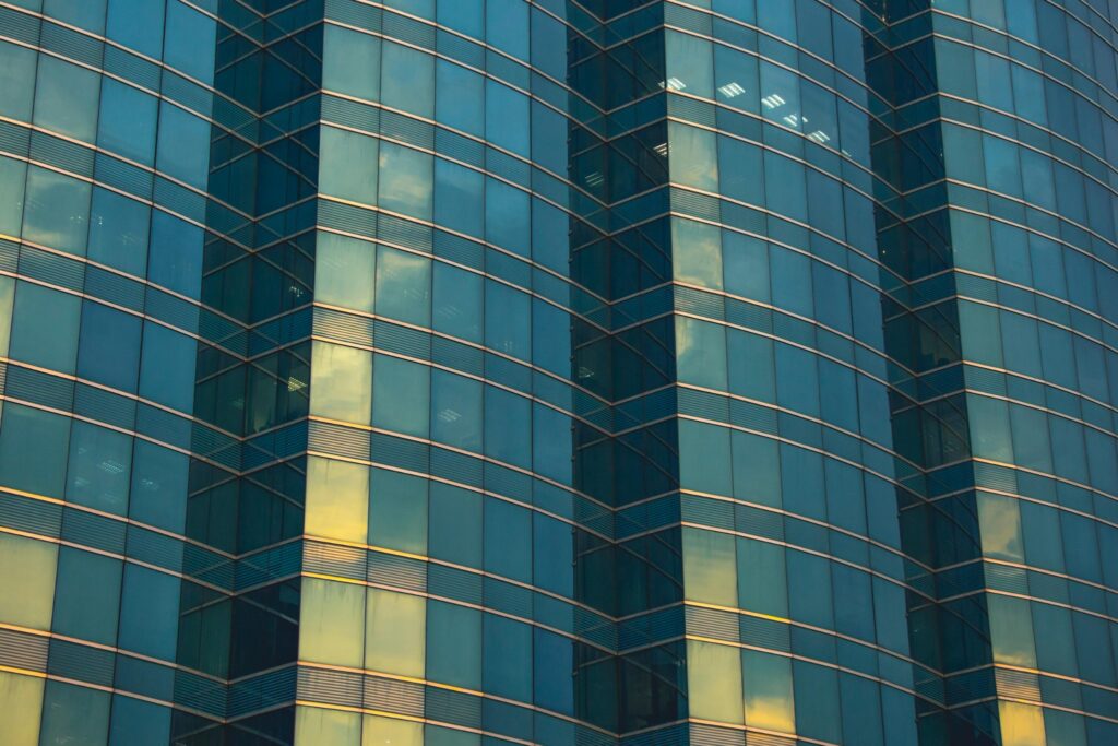 Modern glass office building exterior with reflective windows